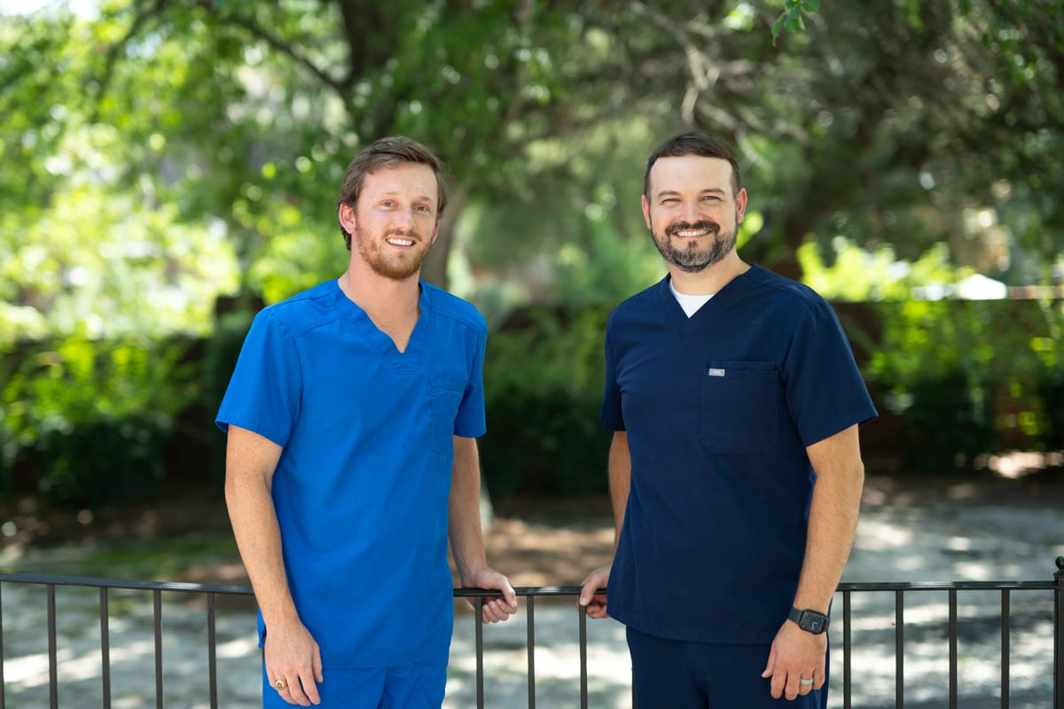 Dr. Joseph McDaniels and Dr. Hampton Scott standing together outdoors near the practice