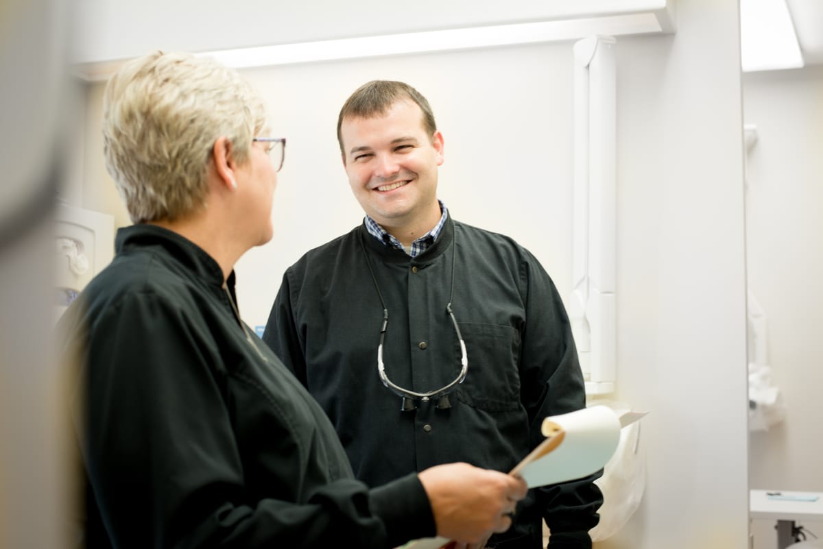 Dr. Joseph McDaniels reviewing a chart with a colleague